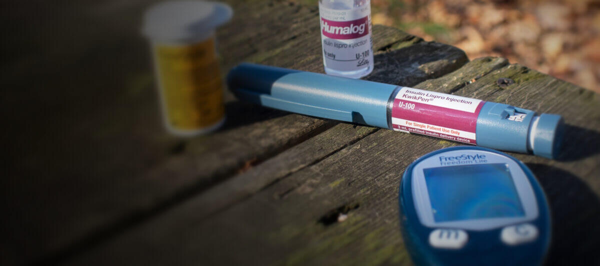 Diabetes care devices and medication sitting atop a table outside